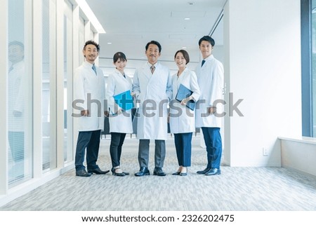 Multiple Asian medical personnel standing in a hospital