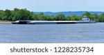 multiple barges being transported on the mississippi river