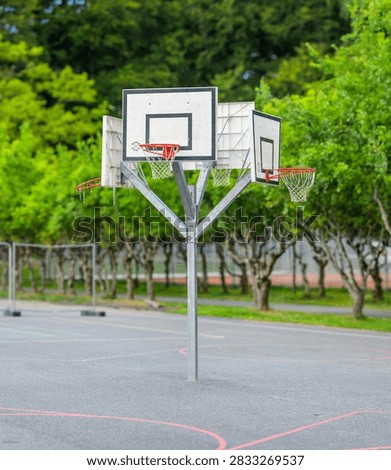 Multiple basketball hoops on empty outdoor sports court