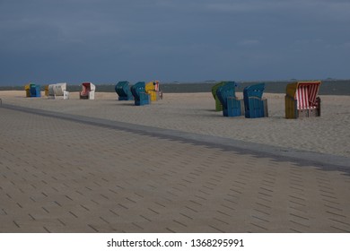 Multiple beach chairs all lined up on the coastline of Föhr