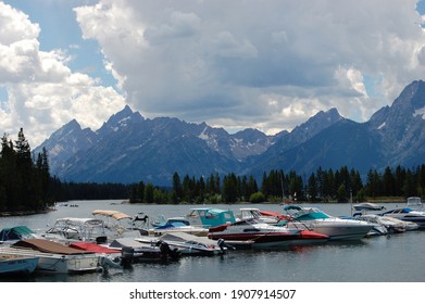 Multiple Boats Lined Up On The Dock Of Yellowstone Lake On A Cloudy Afternoon.