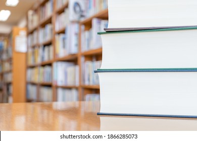 Multiple Books Piled Up In The Library