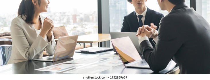 Multiple businessmen having a meeting - Shutterstock ID 1952959639