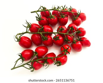 Multiple clusters of ripe cherry tomatoes with green stems displayed on white surface.