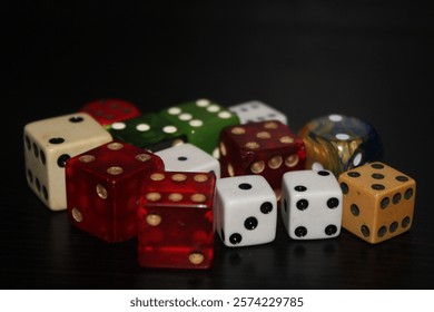 Multiple Colored Dice Laying On A Table With A Black Background. 