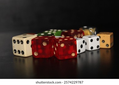 Multiple Colored Dice Laying On A Table With A Black Background. 