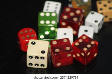 Multiple Colored Dice Laying On A Table With A Black Background. 