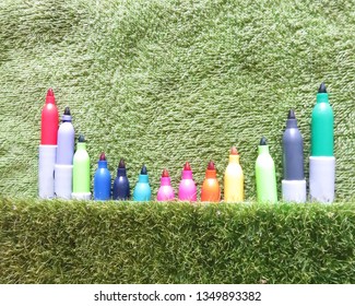 Multiple colored pencils lined with green background