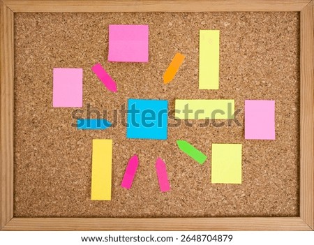 Multiple colorful paper posts, empty backdrop on cork board background, brainstorming concept