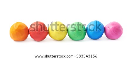Multiple colorful plasticine balls arranged in a line, composition isolated over the white background