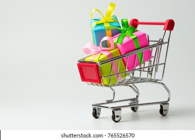 Multiple colors gift or presents boxes in a shopping cart, for sales promotion and rewards concept