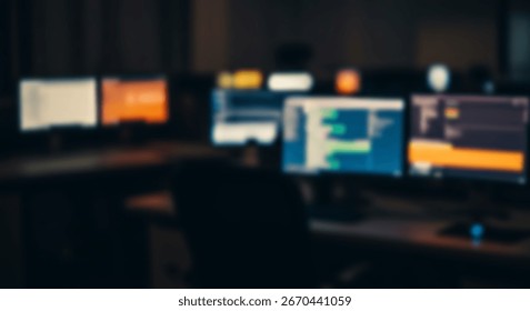 Multiple computer monitors displaying various data in a dimly lit workspace.