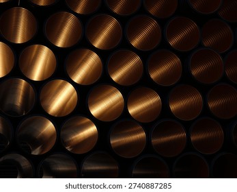 Multiple copper metal pipes are arranged in a repeating geometric pattern with visible circular openings. The image shows an industrial metal surface with warm light reflecting inside the pipes.