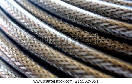Multiple core, armoured steel cable with braded sheath and transparent cover