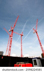 multiple cranes working on huge construction site