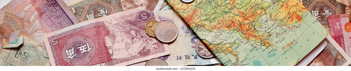 Multiple Currency Notes And Coins With A Map Notebook For Traveling 