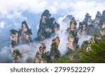Multiple dramatic quartz sandstone pillars rising from the misty valley of Tianzi Mountain in Zhangjiajie National Forest Park China