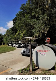 Multiple Empty Golf Carts Parked Near Gasoline Fuel Tank