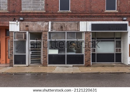Multiple empty storefronts on old street in a forgotten neighborhood in urban Detroit