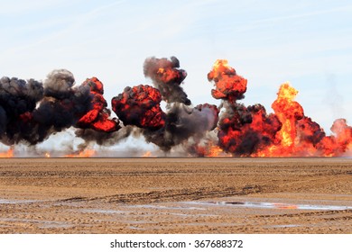 Multiple  explosions on a sandy beach
