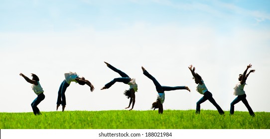 Multiple Exposure Capturing An African American Woman Doing A Back Flip In A Beautiful Field.