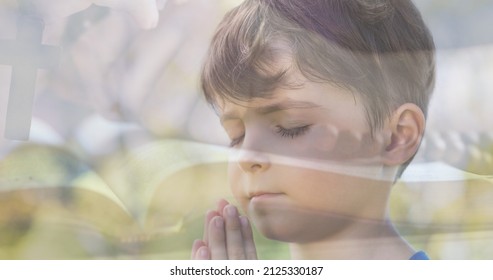 Multiple exposure of caucasian boy praying with hand holding rosary on bible in background. spirituality, religion, worshipper, meditation, christianity and national day of prayer. - Shutterstock ID 2125330187