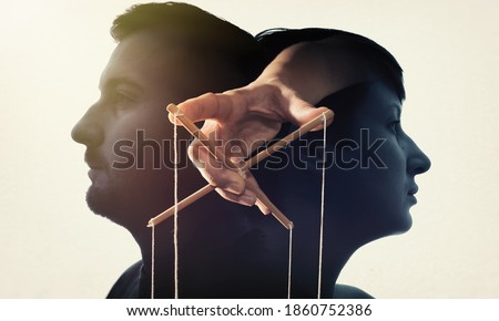 Multiple exposure with man and woman silhouette and controlling hand with wooden cross. Concept of control. 