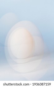 Multiple Exposure Of White Duck Egg On Light Blue Background