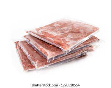 Multiple frozen meat packages in a pile, vacuum sealed. Ground chicken inclusive backs, necks, liver and heart. Concept for raw food diet for cats, dogs and pets. Isolated on white. - Shutterstock ID 1790328554
