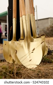 Multiple Gold Shovels Stacked Waiting For Ground Breaking Ceremony. 