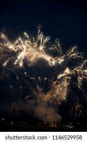 Multiple golden fireworks exploding in the sky