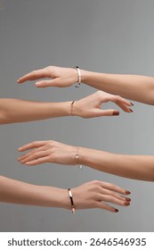 Multiple hands display different bracelets in a visually appealing manner, emphasizing the intricate designs and variety of materials used in contemporary jewelry fashion.