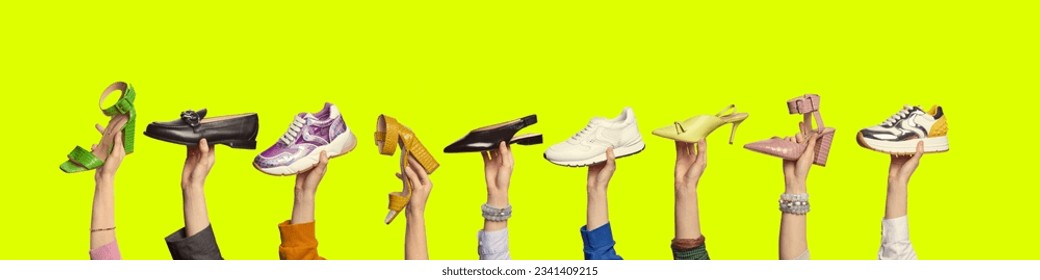 Multiple hands holding modern shoes of different colors and styles on isolated bright yellow background with copy space. Shoe summer sale, discount concept. Fashion blog. - Powered by Shutterstock