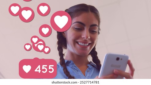 Multiple heart icons with increasing numbers floating against caucasian using smartphone. social media networking and technology concept