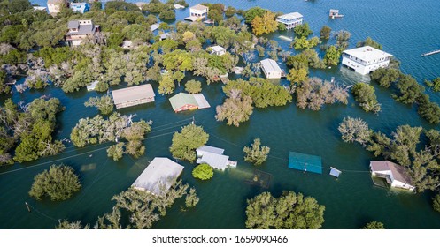multiple houses half under water Aerial drone views high above Flooding caused by Climate Change