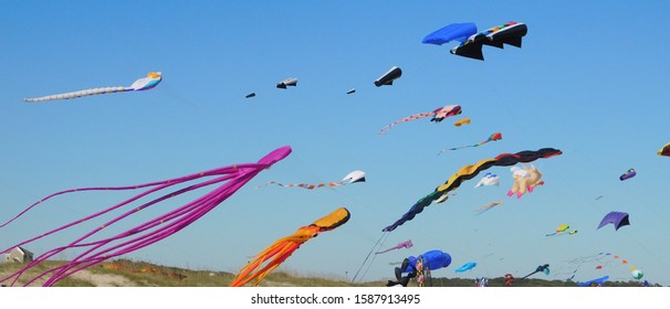 Multiple Kites Flying At Kite Festival On The Beach