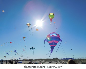 Multiple Kites Flying On A Sunny Beach Day