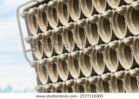 Multiple launch rocket system barrels. sky background. close-up