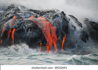 Multiple Lava Flows, Ocean, Steam, close up. Red hot lava flows through lava tubes and pours like rivers into the ocean, bringing up clouds of steam and toxic gas, adding new land to the Big Island - Powered by Shutterstock