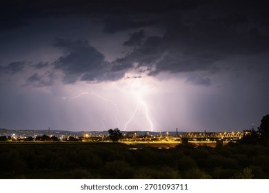 Multiple lightning during thunderstorm at night, over hills near croatian city of Slavonski Brod