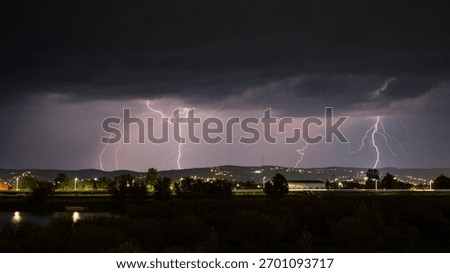 Multiple lightning during thunderstorm at night, over hills near croatian city of Slavonski Brod