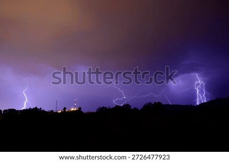 Multiple lightning strikes hitting the ground during a severe weather event.