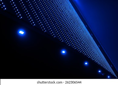 Multiple little blue lights on abstract building