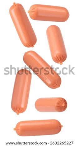 Multiple mini hot dogs falling against a transparent background