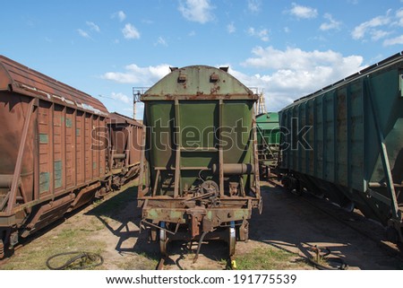 Multiple old industrial train wagons on rail tracks