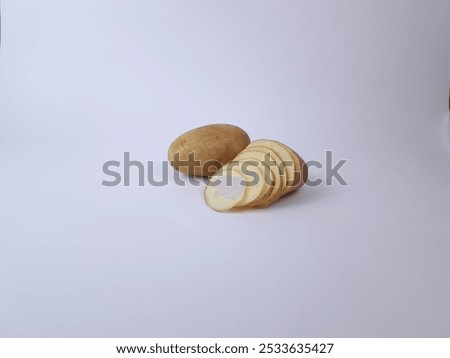Multiple potatoes cut into thin slices isolated on white background 