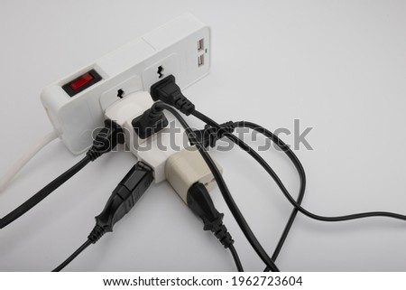 Multiple power socket with connected plugs , Multi plug electrical power strip on a white background , Unsafety concept