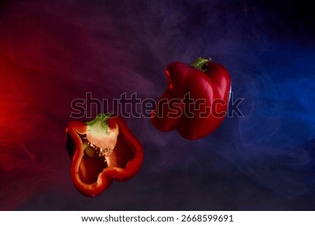Multiple red bell peppers placed together against dark background