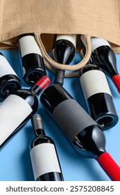 Multiple red wine bottles rolling out of a bag onto a vibrant blue background. A dynamic and colorful arrangement, ideal for wine, lifestyle, or creative advertising projects.