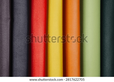 Multiple rolls of textured leather in a rainbow of colors.